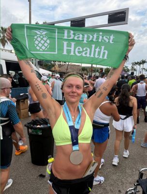 PBRS ambassador holding a Baptist Health banner