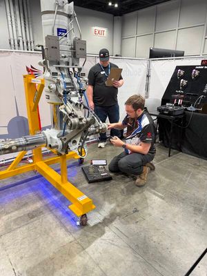 MRO Americas — mechanic kneeling at engine