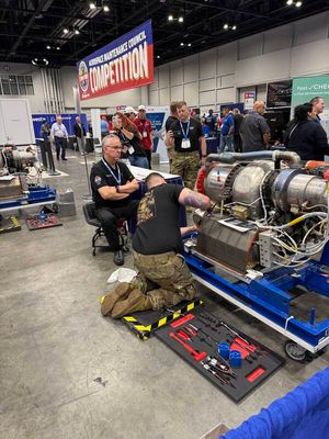 MRO Americas — technician crouching at landing gear